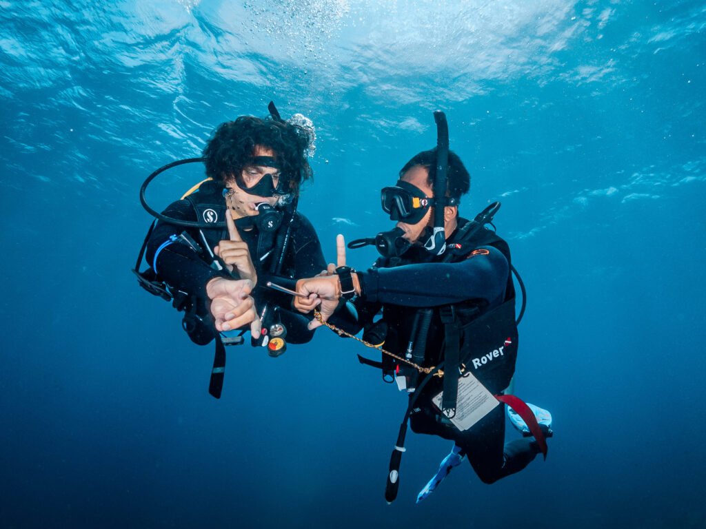 Student diver underwater with an instructor on a rescue dive course by GaiaOne in Bira, South Sulawesi, Indonesia